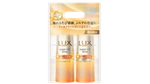 ベージュの背景に配置された、オレンジ色の花柄デザインのLUX スーパーリッチシャイン シャンプー&コンディショナーのツインパック
