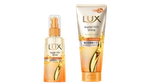 シンプルな背景に配置された、オレンジとゴールドのパッケージデザインのLUX スーパーリッチシャイン ヘアケア製品2点